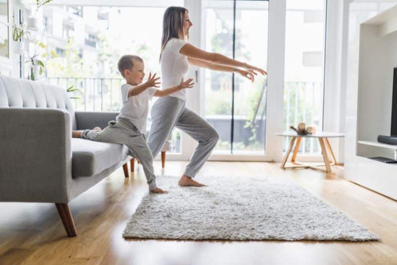 mom exercising with son in living room