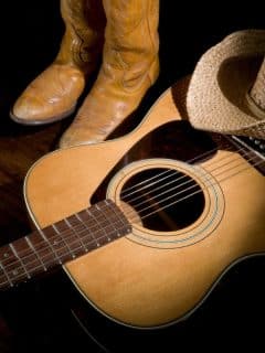 country guitar, cowboy boots, and a hat