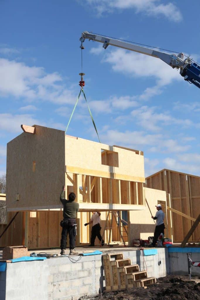 workers putting new build house together