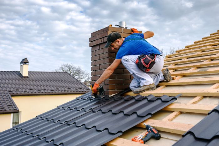 roofing contractor putting screws in roof