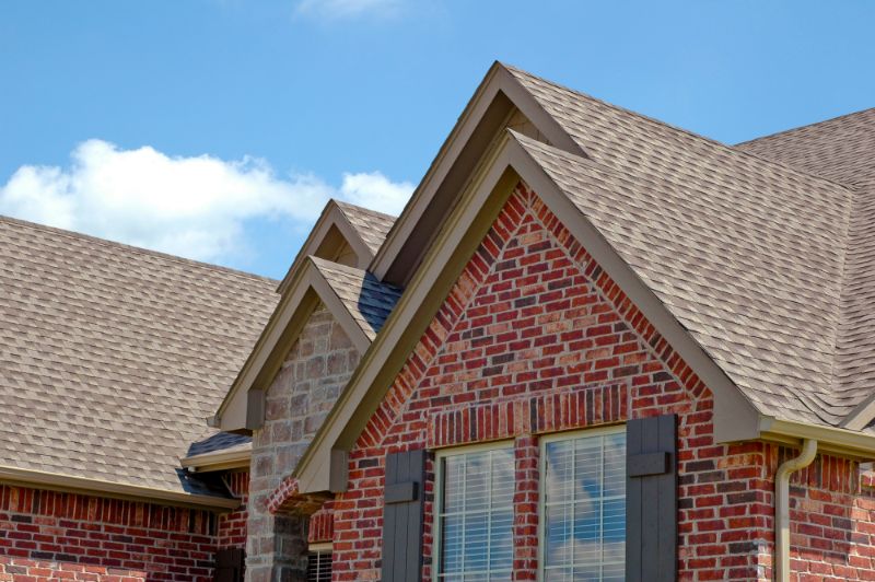 brick home with shingled roof