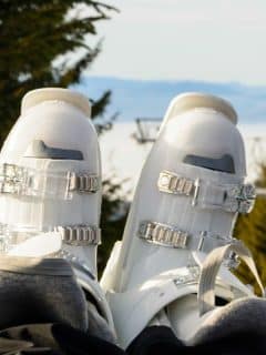 ski boots in foreground and winter scenery in background