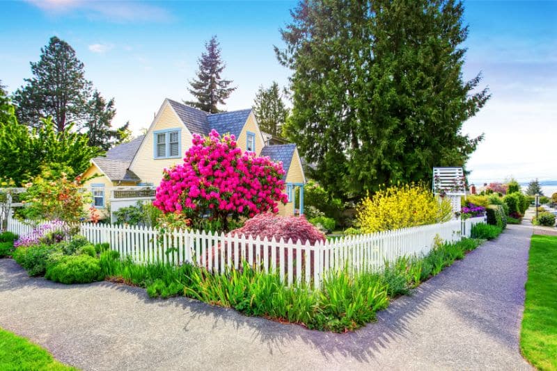 white picket fence around a cute house