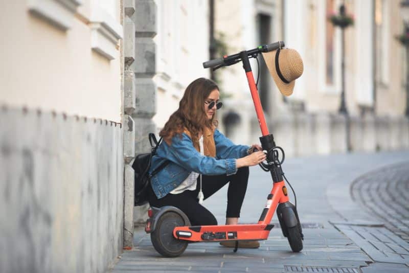woman securing e-scooter