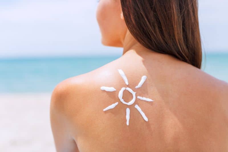 woman with sunscreen on shoulder