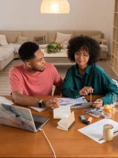 a man and woman working on their finances together