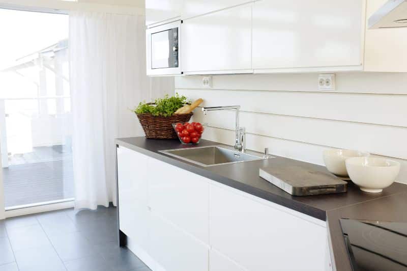 bright kitchen with dark countertops and floors