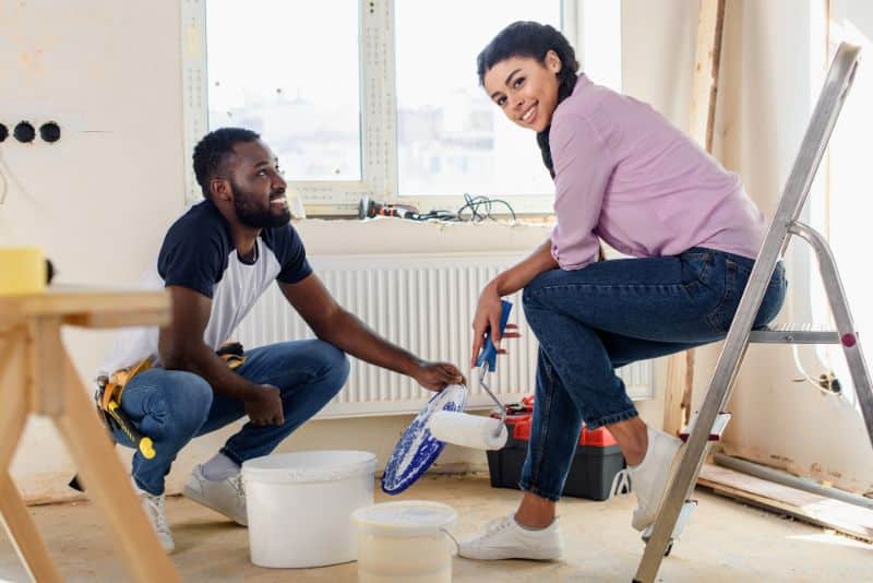 smiling couple working on home renovations