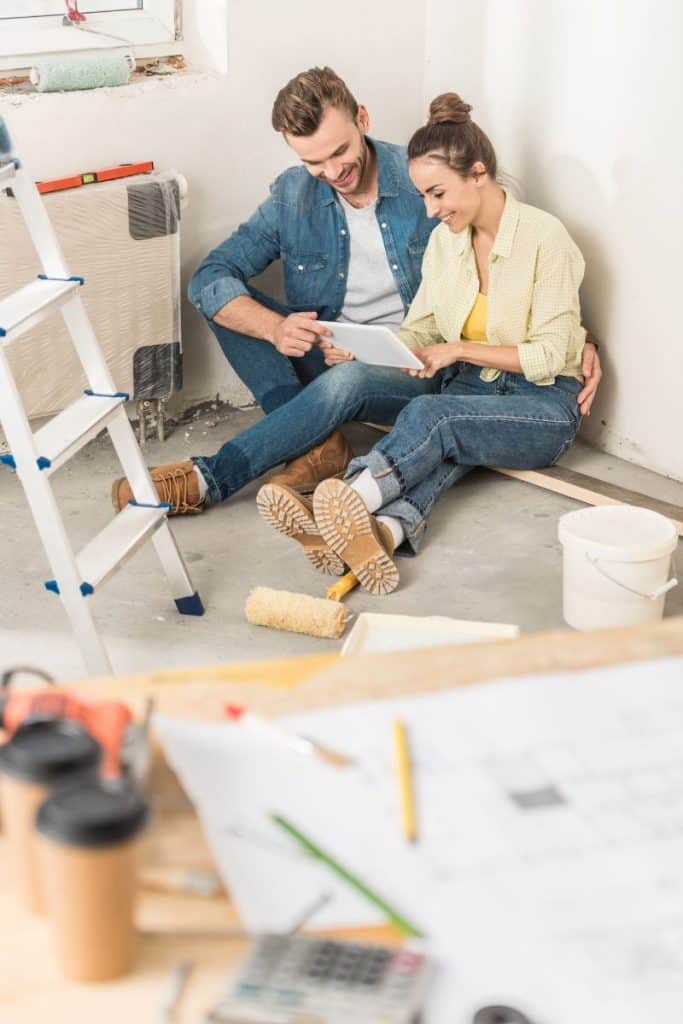couple looking at tablet during home renovation