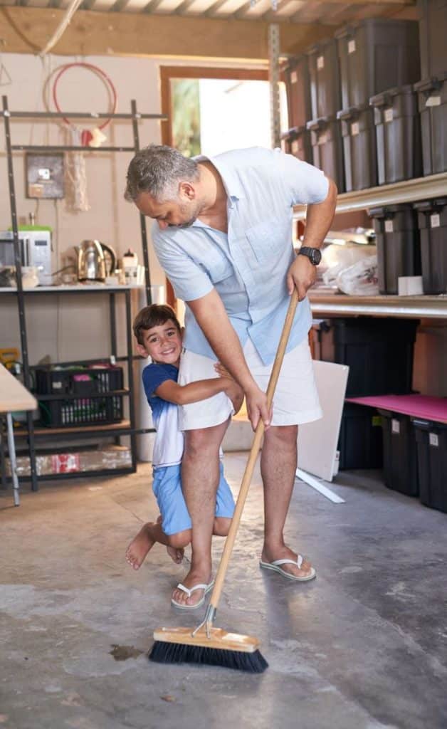 father and son cleaning up the garage