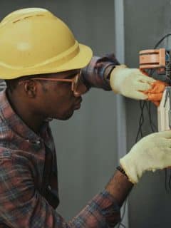 electrical technician working on a fuse box