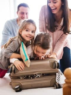 family packing suitcase for vacation