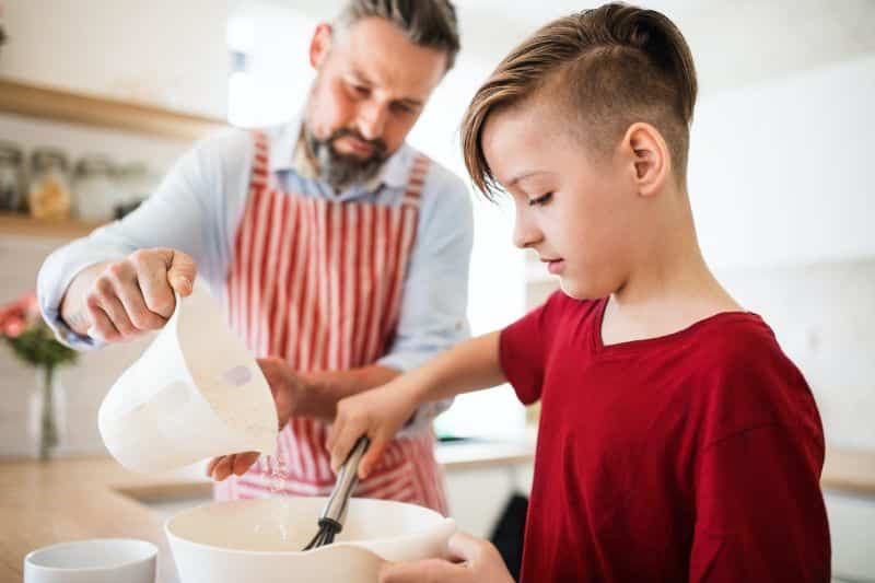father and child cooking together
