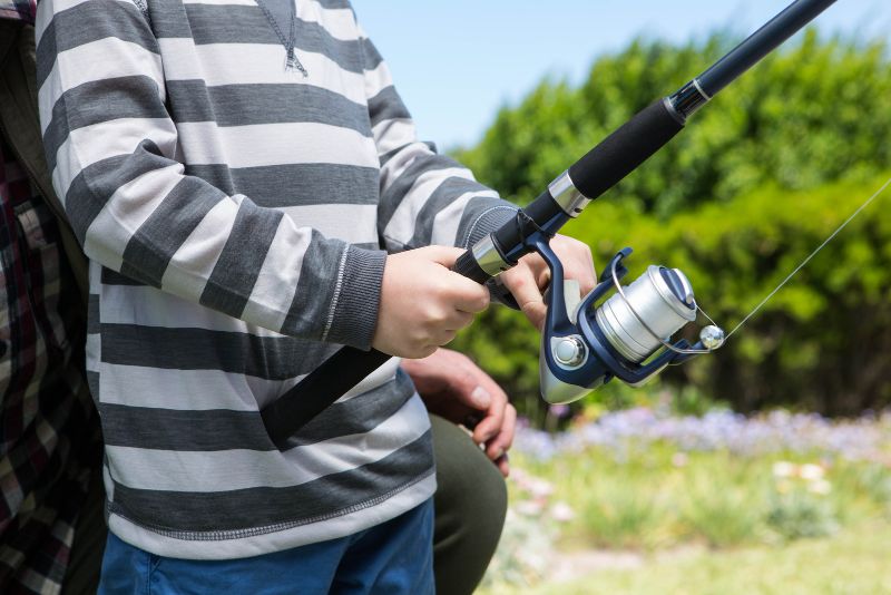 child using fishing reel