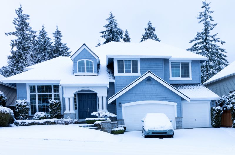a large home in the winter with snow