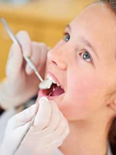 girl getting a dental checkup