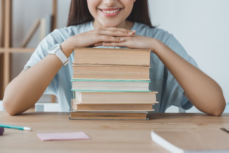 girl with books on a table