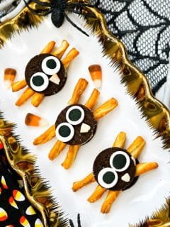 3 oreo spiders on a plate with gold trim
