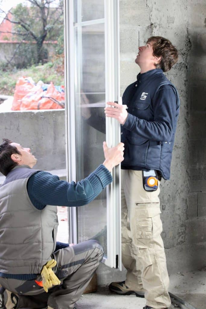 two men installing a window