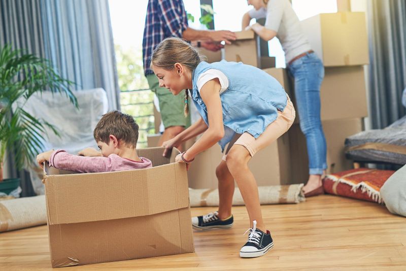kids playing in boxes on move-in day