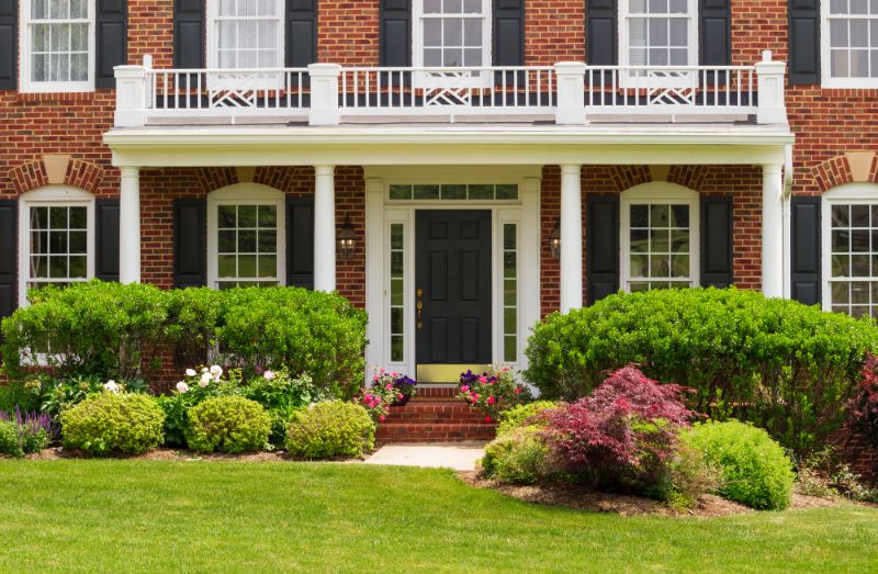 large brick home with manicured yard