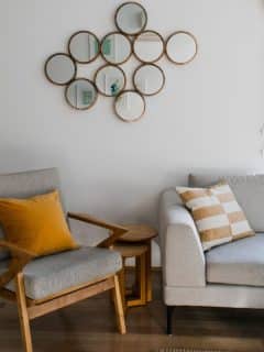 modern living room with circle mirrors on wall