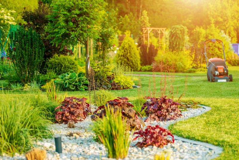 beautifully landscaped yard with mower in distance