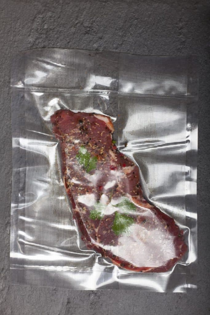 meat with herbs and seasonings in a sous vide bag