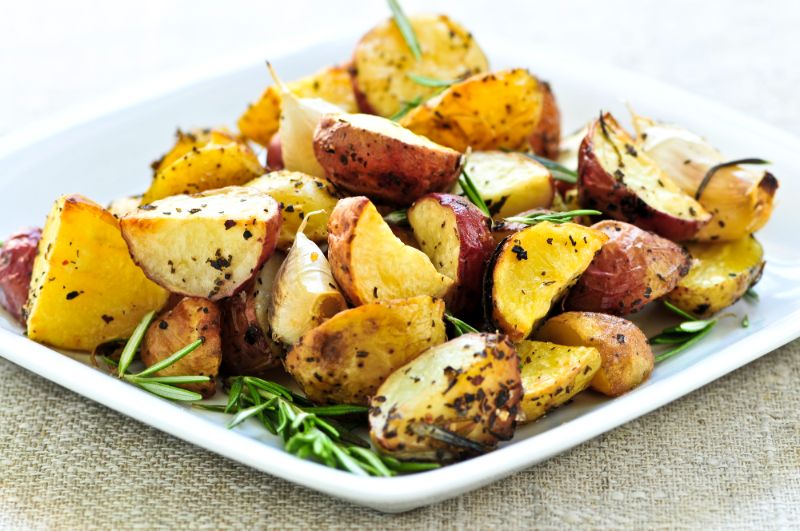 roasted potatoes and rosemary on white plate