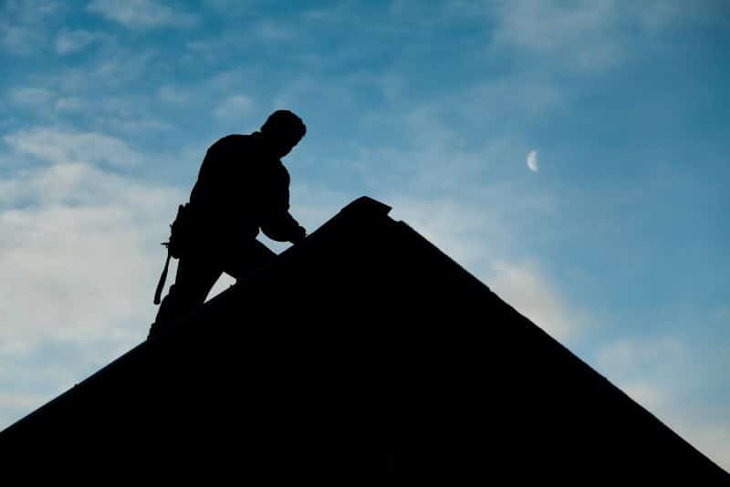 roofer in silhouette on gable