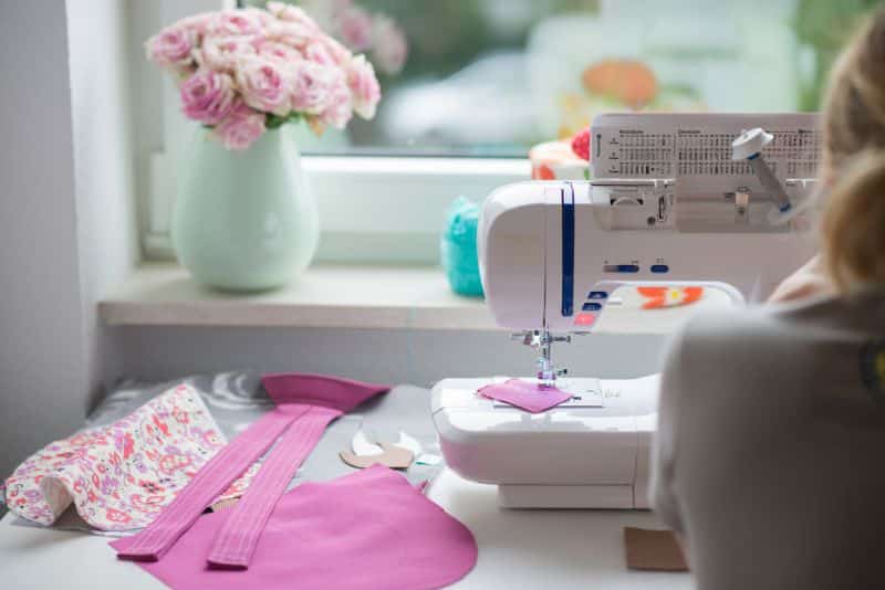 sewing room with flowers in window