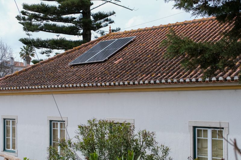 solar panel on roof of white house