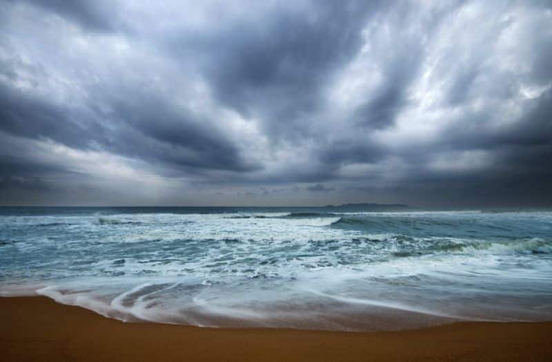 stormy beach - rough water with dark storm clouds overhead