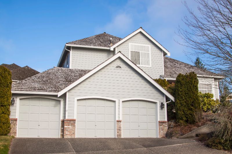 large suburban home with multiple garages