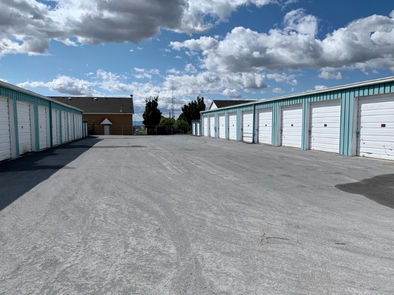 blue and white storage units with parking lot between