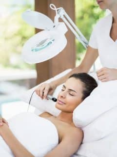 woman in salon receiving a facial massage