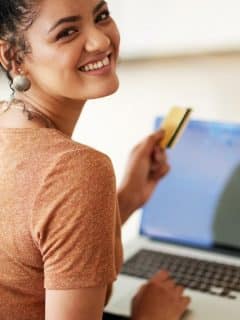 woman smiling while shopping online