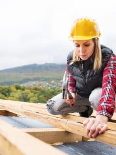 female contractor working on roof