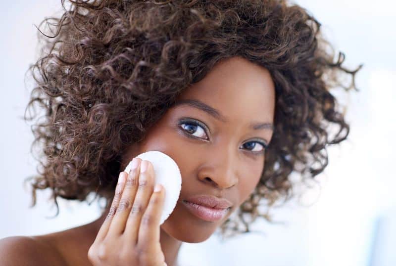 applying makeup to face with sponge