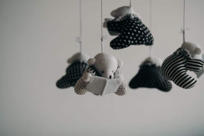 black and white teddy bear mobile in nursery