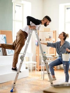 couple on ladder doing home renovations