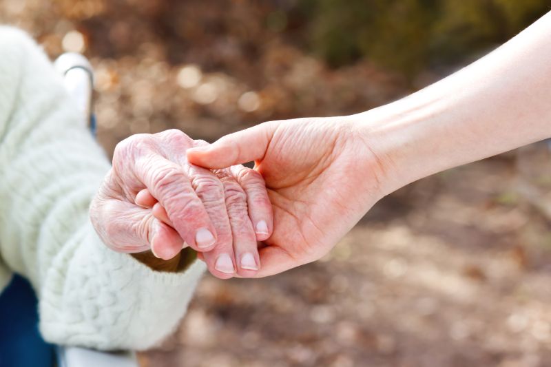 holding elderly mom's hand
