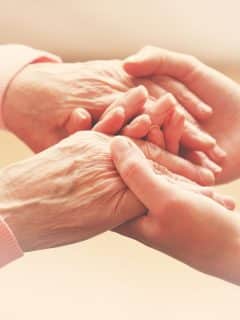 holding hands with elderly mother