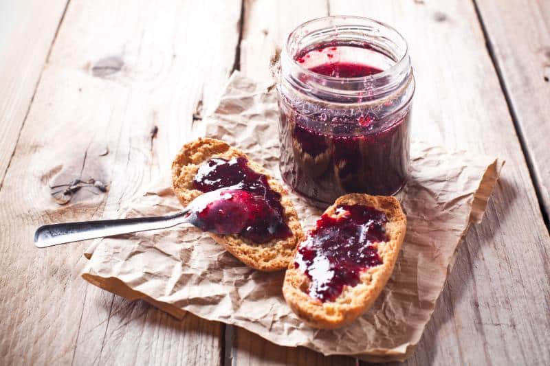 jar of black currant jam and toast