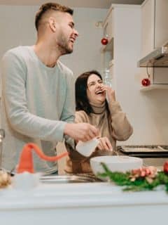 couple laughing together in the kitchen