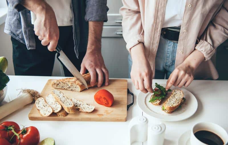 couple prepping sandwiches together