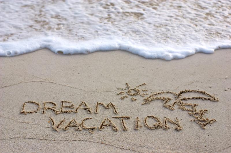 dream vacation written in the sand
