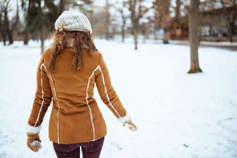 woman in warm coat in the snow