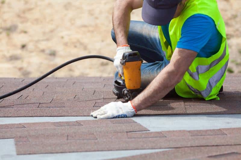 roofer installing shingles