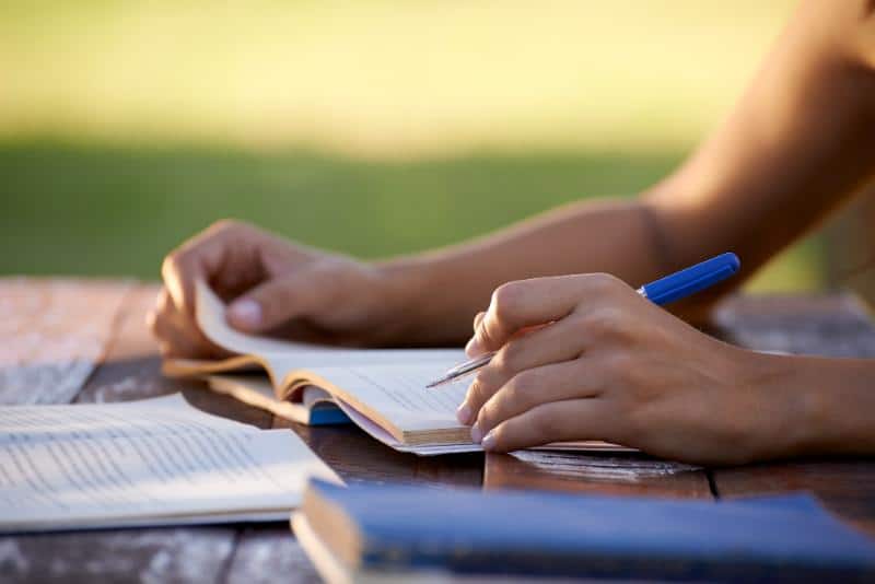 student studying and marking a book